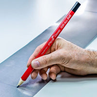 Hand marking a line on a piece of metal with a Pica Classic FOR ALL Pencil