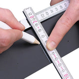 Hands holding a ruler and marking a line on an object with a white Pica pencil